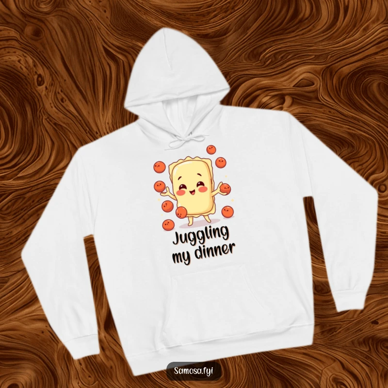 Soft hoodie featuring a playful ravioli character expertly juggling tiny meatballs, perfect for cozy, humorous wear.